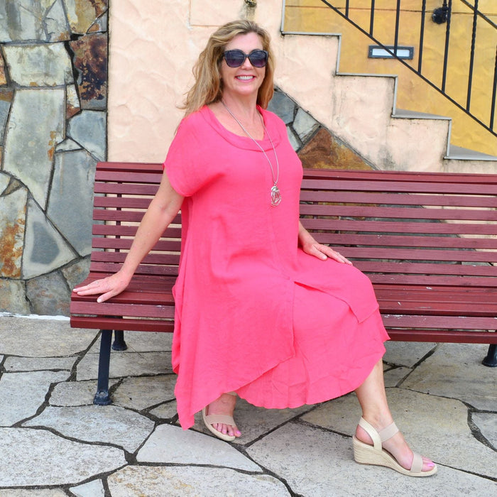 Wishstone coral drop shoulder tunic dress with flowing fabric and relaxed fit, displayed on a hanger.