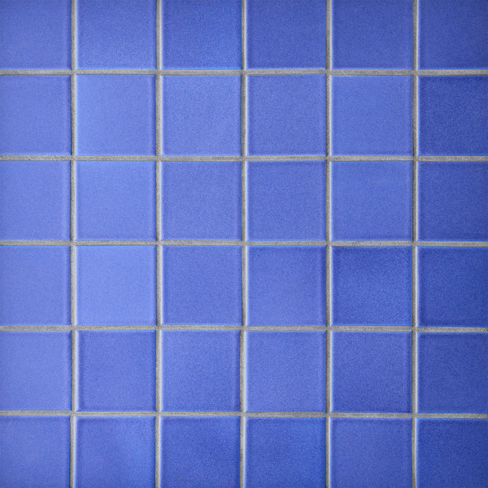 Caption: Classic Field 3x3 in M139 Ultramarine. Prism Dove Grey grout by Custom Building Products.
