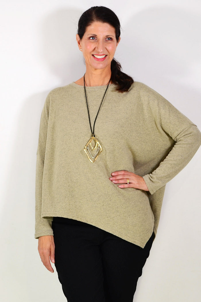Green drop shoulder tunic top by Peony featuring an angled hem and relaxed fit, displayed on a hanger.