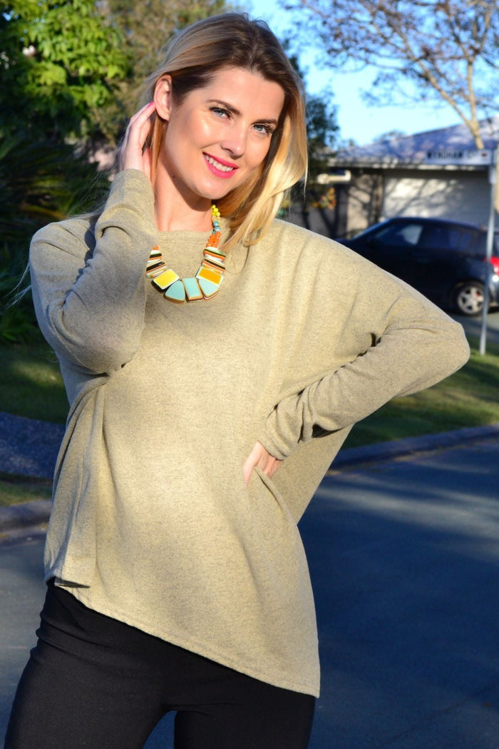 Angle green drop shoulder tunic top by Peony, featuring a relaxed fit and stylish design, displayed on a hanger.