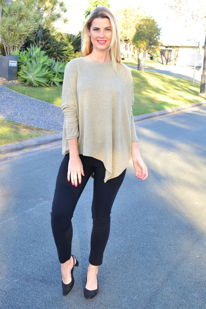 Green drop shoulder tunic top by Peony featuring an angled hem and relaxed fit, displayed on a model.