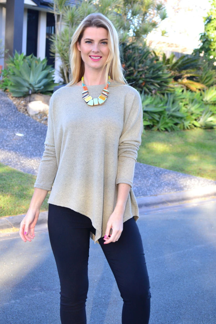 Peony green drop shoulder tunic top with angled hem and relaxed fit, displayed on a hanger with soft fabric detail.