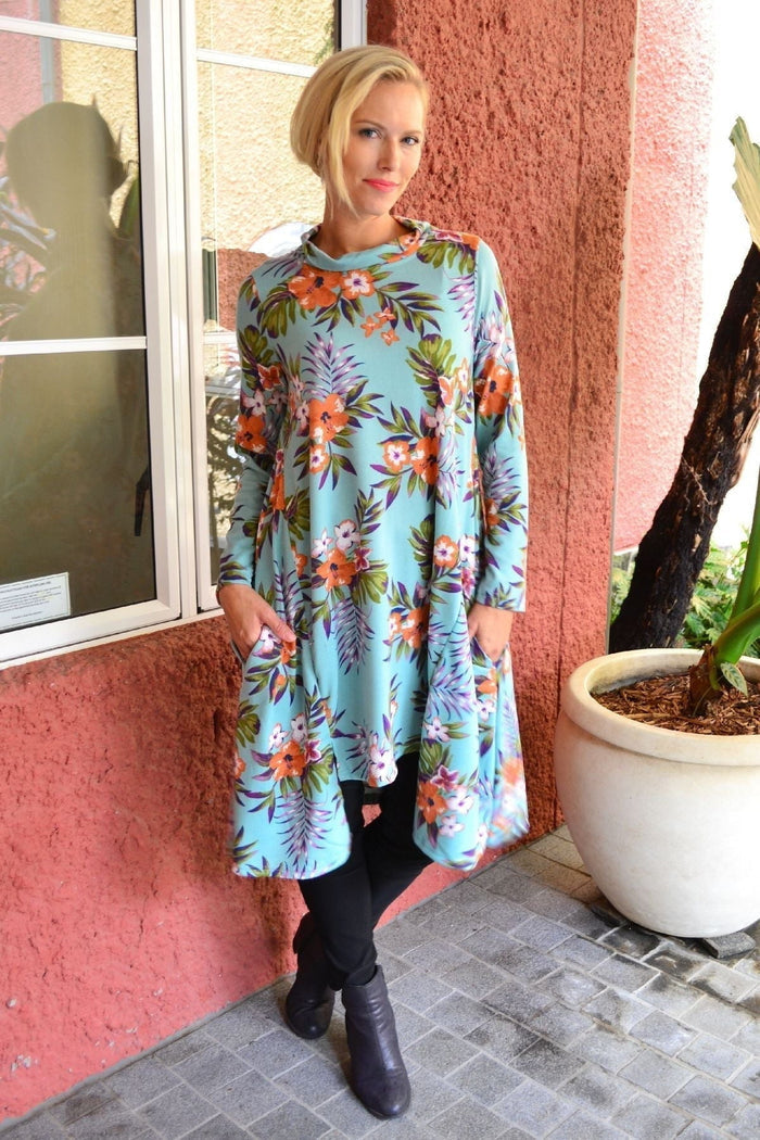 Aqua orange hibiscus fleece tunic dress by Hourglass, featuring a relaxed fit and vibrant hibiscus floral pattern.