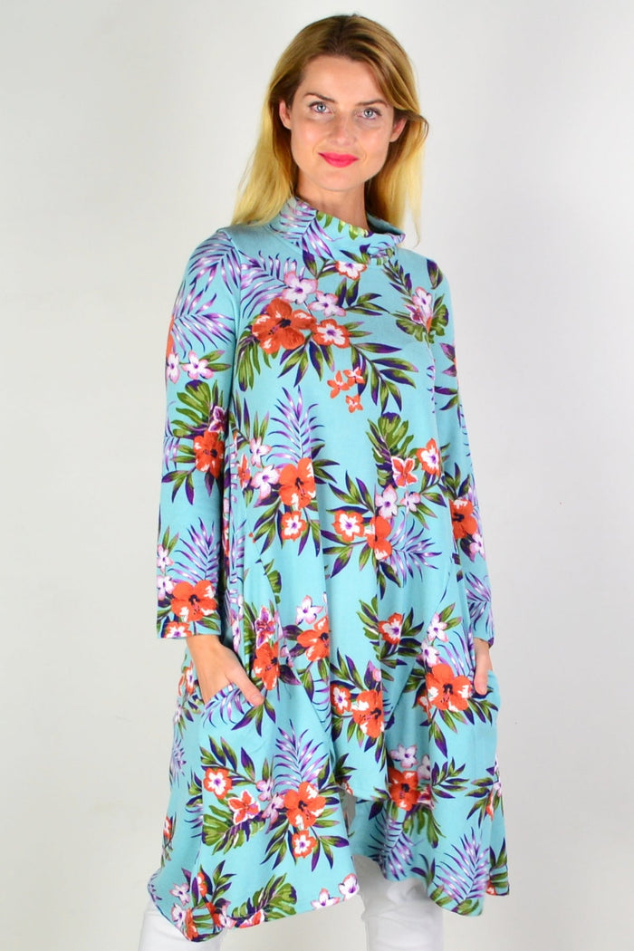 Aqua orange hibiscus fleece tunic dress by Hourglass featuring a relaxed fit and vibrant floral pattern, displayed on a hanger.