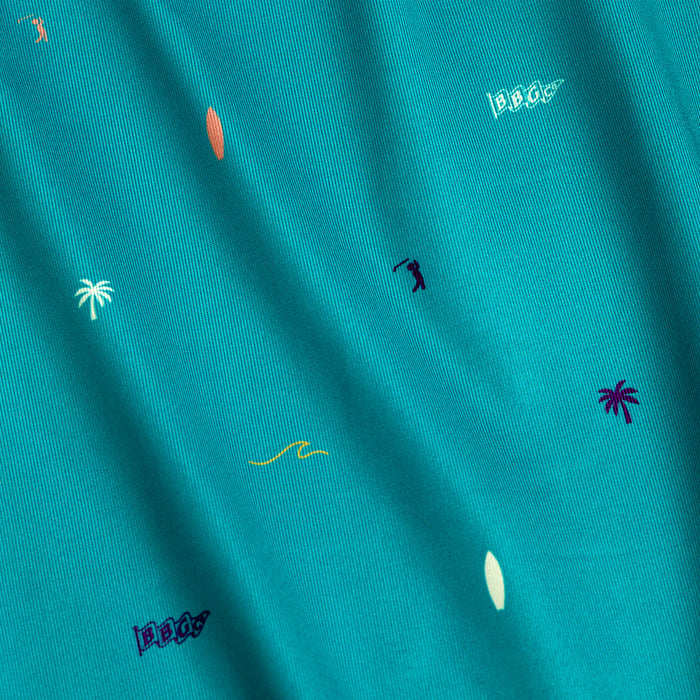 The Beach - Polo features teal fabric with playful embroidered icons like palm trees and surfboards. Its athletic fit, moisture-wicking properties, and subtle fabric folds ensure you stay cool, comfortable, and stylish with a beach vibe.
