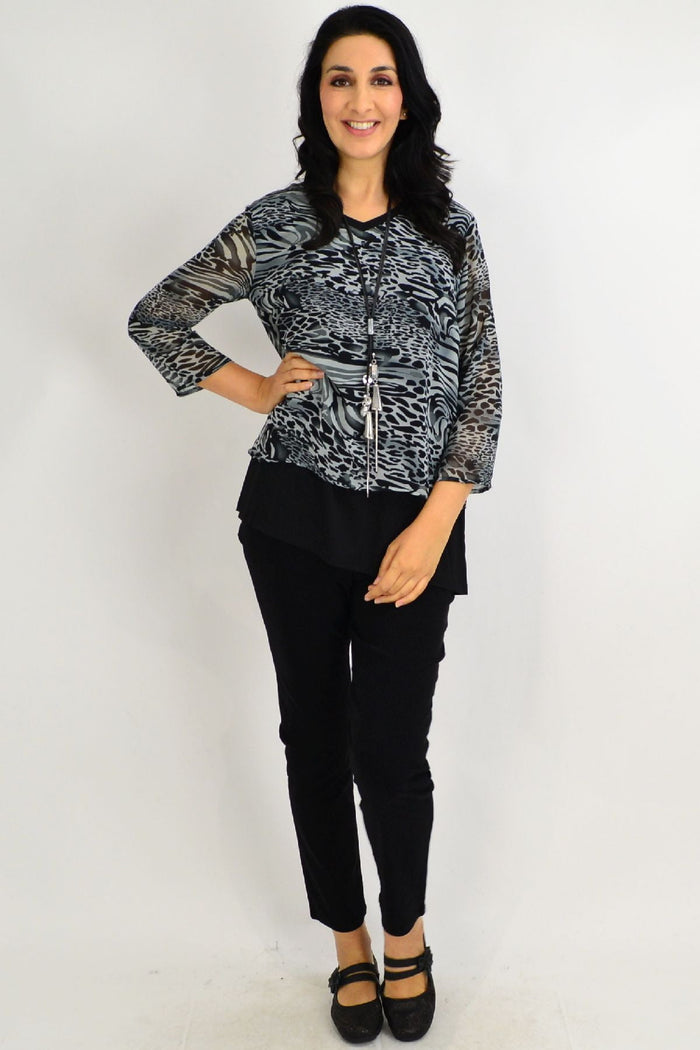 Black Annie animal print tunic top by Stylius, featuring a stylish animal pattern and relaxed fit, displayed on a hanger.