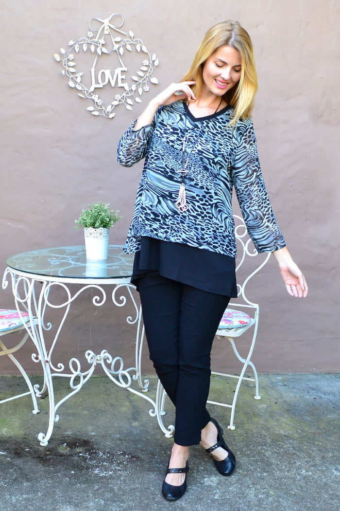 Black Annie Animal Print Tunic Top by Stylius, featuring a stylish animal pattern and relaxed fit, displayed on a hanger.