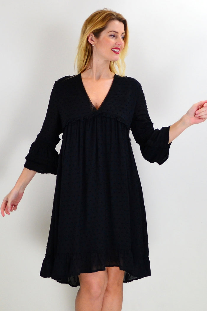 Black bohemian tunic dress from New U Collection with flowing fabric and relaxed fit, displayed on a hanger.
