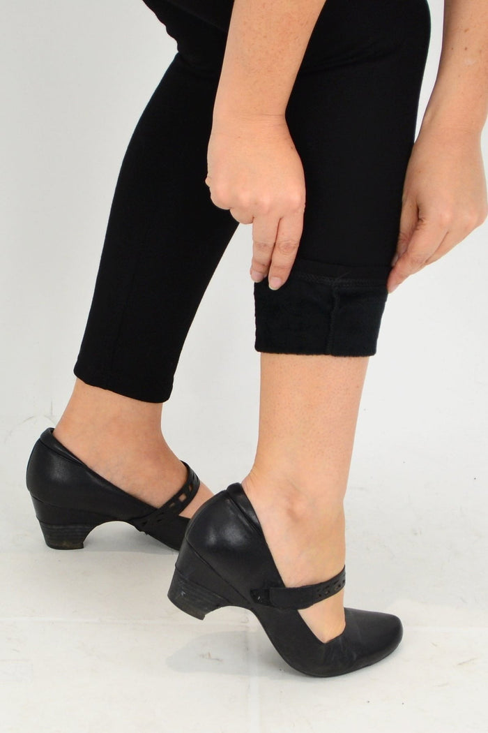 Black winter warm fleece-lined leggings by Whispers, showing the cozy, fitted fabric ideal for cold weather.