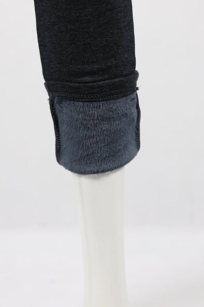 Black winter warm fleece-lined leggings by Whispers, showing close-up of soft, cozy fleece interior and stretchy fit.