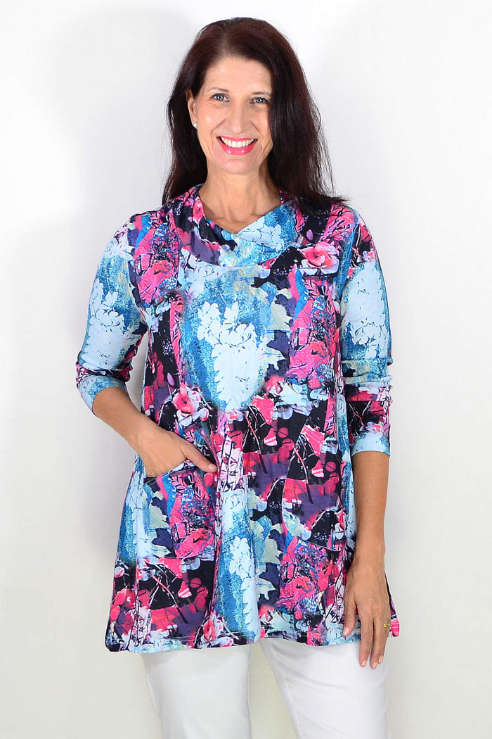 Blue floral leaves Wishstone tunic top with long sleeves and a relaxed fit, featuring vibrant floral and leaf patterns.