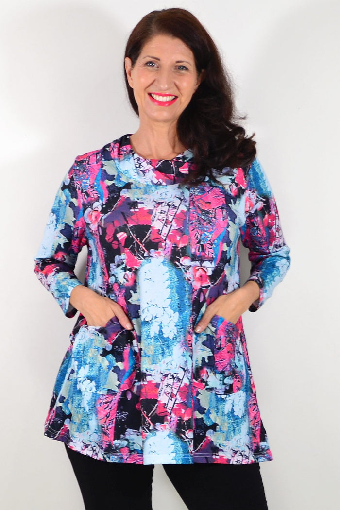 Blue floral leaves Wishstone tunic top with long sleeves and relaxed fit, featuring a vibrant botanical pattern.