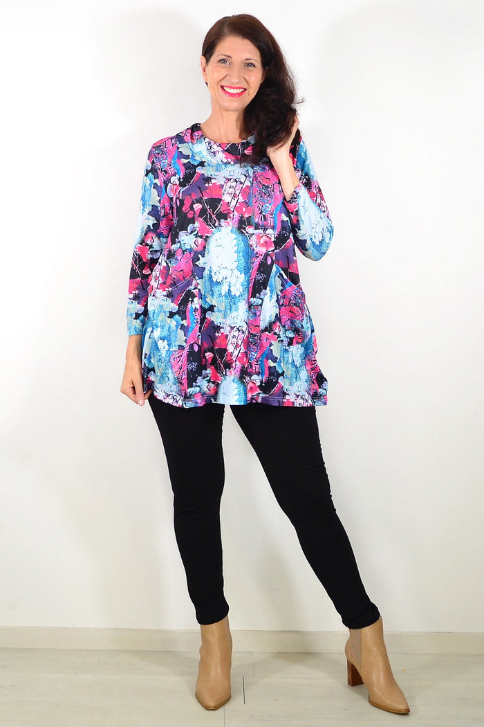 Blue floral leaves Wishstone tunic top with long sleeves and relaxed fit, featuring vibrant botanical print.