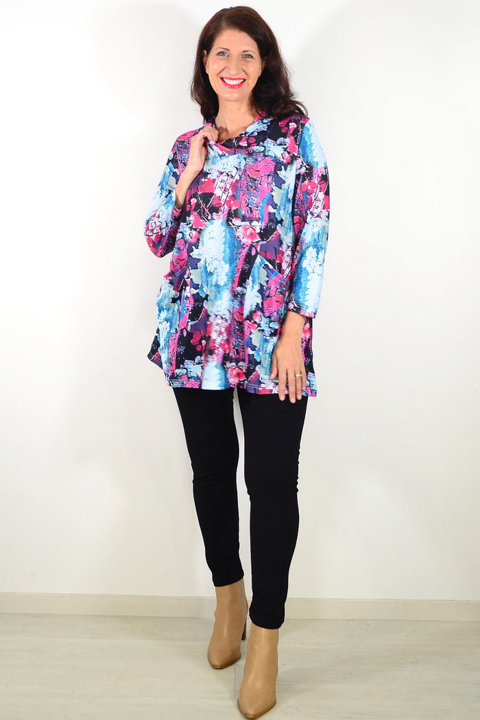 Blue floral leaves Wishstone tunic top displayed on a hanger with detailed fabric pattern and vibrant colors.
