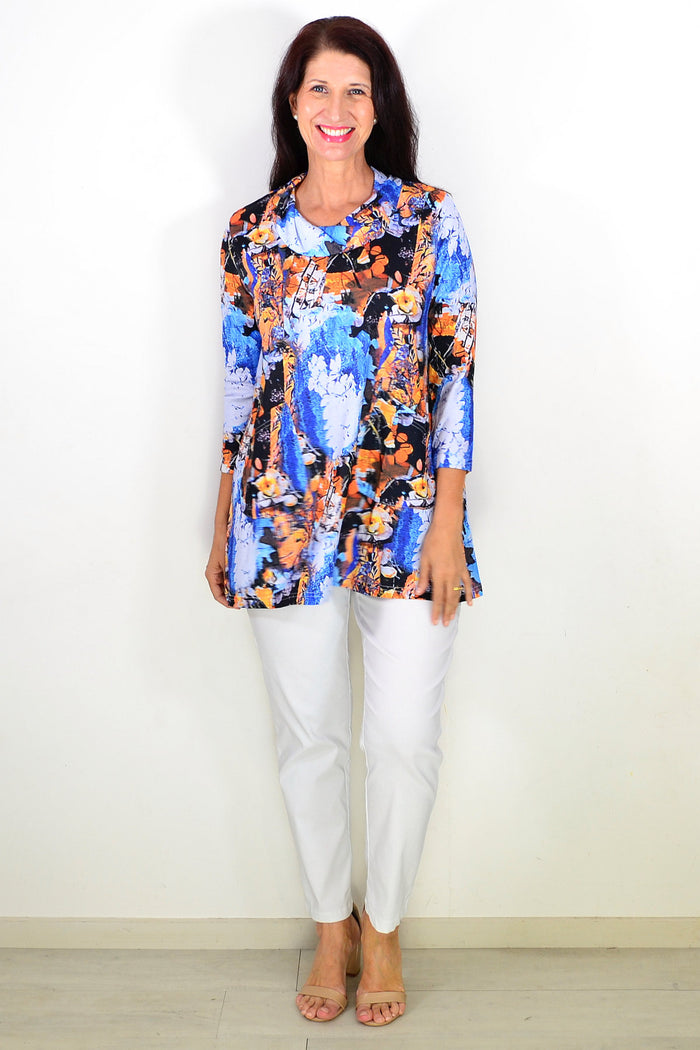 Blue orange floral print Wishstone tunic top with long sleeves and relaxed fit, displayed on a hanger.