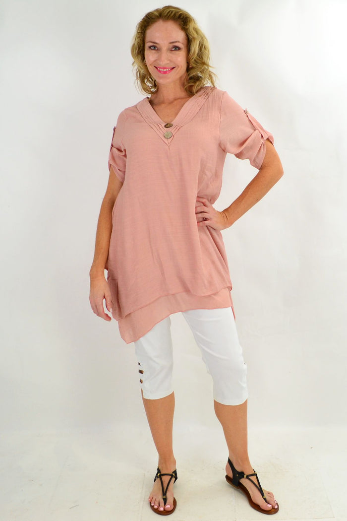 Blush coconut button short sleeve tunic top by La Mode, featuring a relaxed fit and front button details, shown on a hanger.