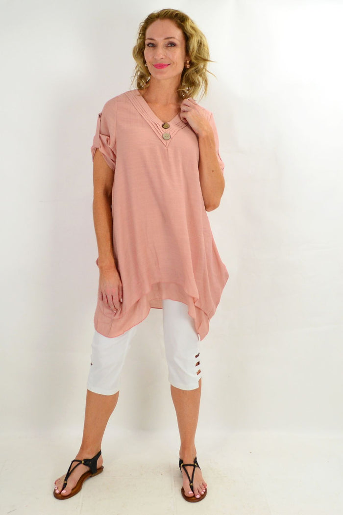 Blush coconut button short sleeve tunic top by La Mode, featuring a relaxed fit and stylish design, shown on a hanger.