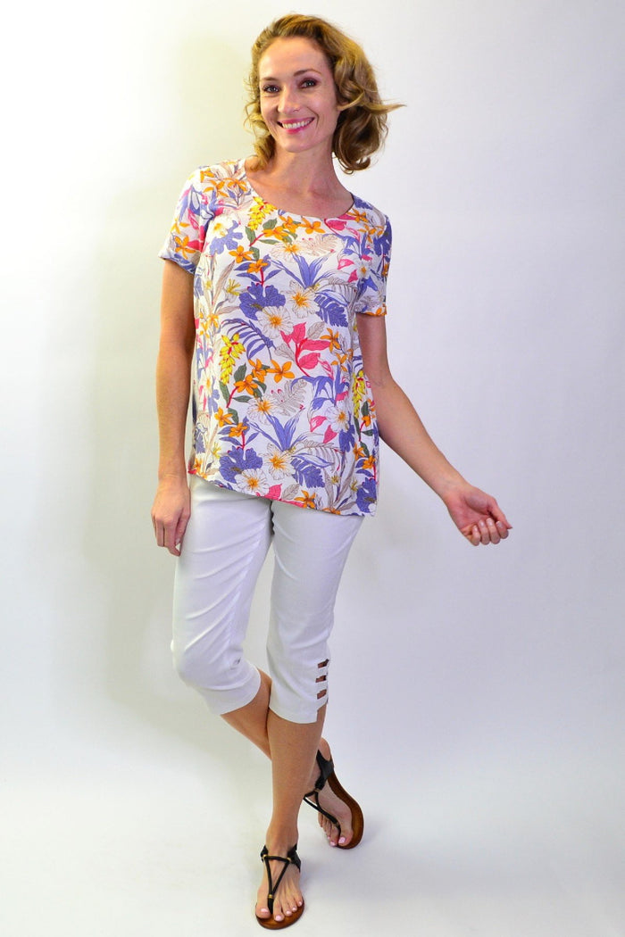 Stylius Botanical Garden Tunic Blouse featuring floral patterns and lightweight fabric, displayed on a hanger against a neutral background.