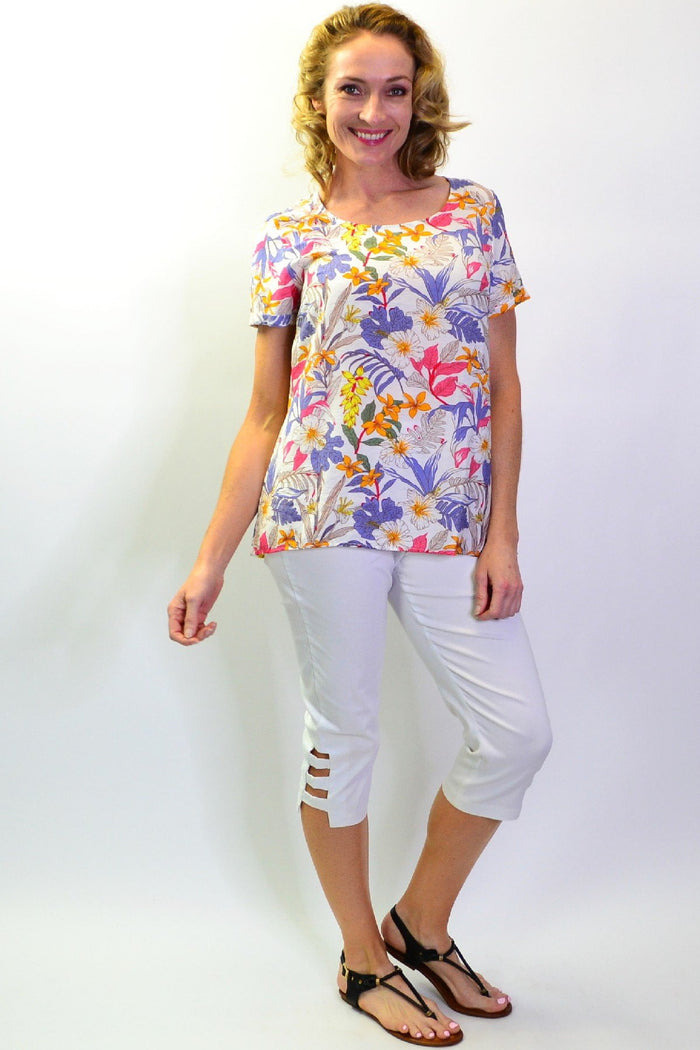 Stylius Botanical Garden tunic blouse with floral print, lightweight fabric, and relaxed fit, displayed on a hanger.