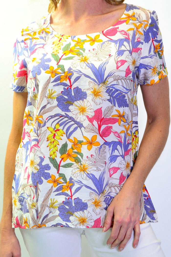 Stylius Botanical Garden Tunic Blouse with vibrant floral print, lightweight fabric, and relaxed fit displayed on a hanger.