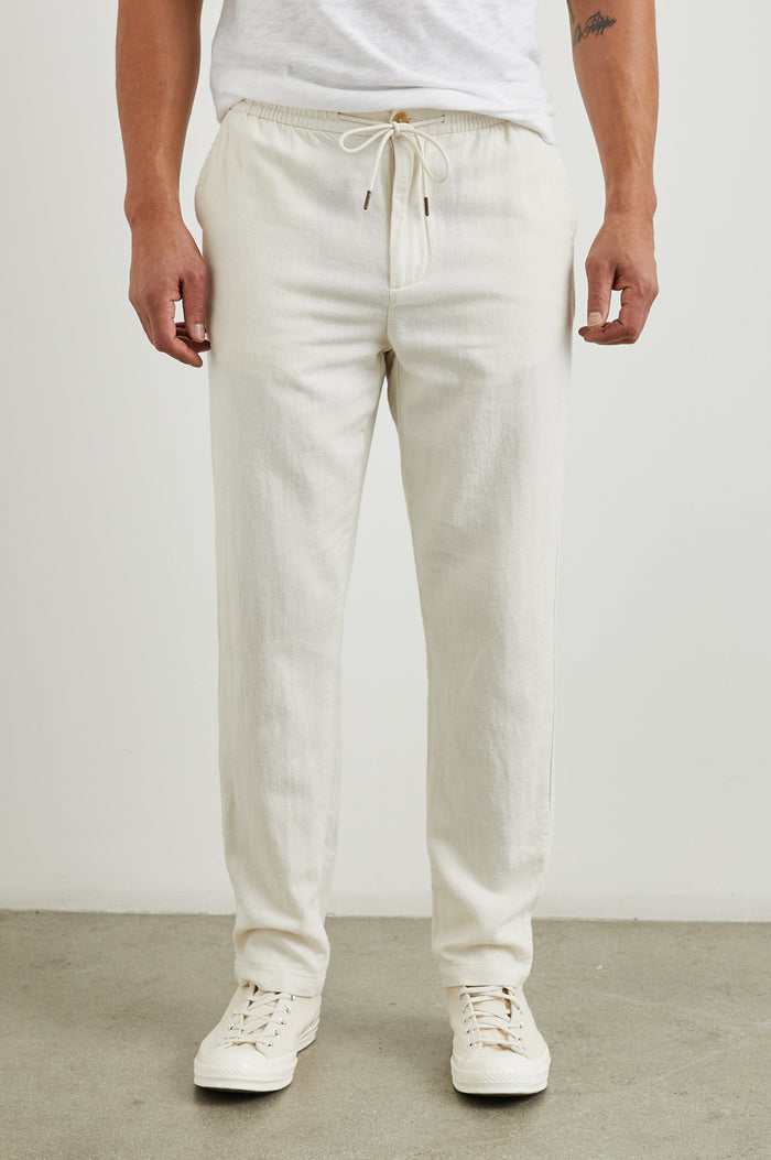Callum Pants with a Drawstring Waist, Two Front Pockets and a Back Patch Pocket in Ecru Colorway - Front View Featured on Model