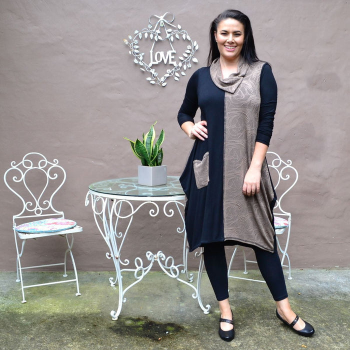 Camel swirl sleeveless winter tunic dress by Whispers, featuring a stylish pattern and comfortable fit, displayed on a hanger.