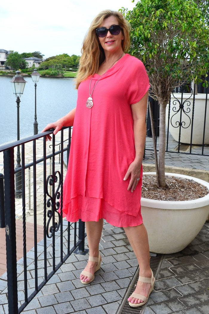 Wishstone coral drop shoulder tunic dress featuring a relaxed fit and flowing fabric, displayed on a model.