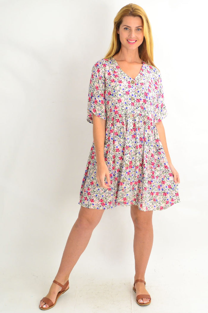 Cream coconut button pocket tunic dress by Silver Wishes, featuring a relaxed fit and stylish pockets, displayed on a hanger.