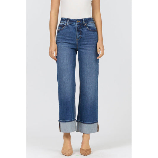 Blue jeans worn by a person on a white background