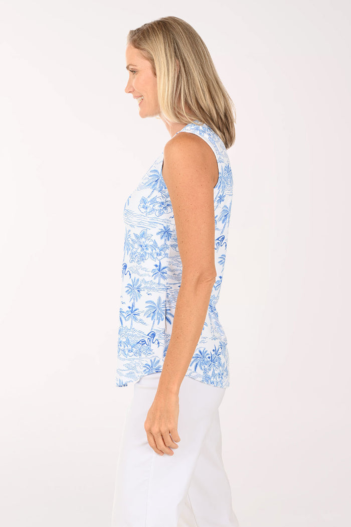 Woman wearing a sleeveless white and blue palm tree top