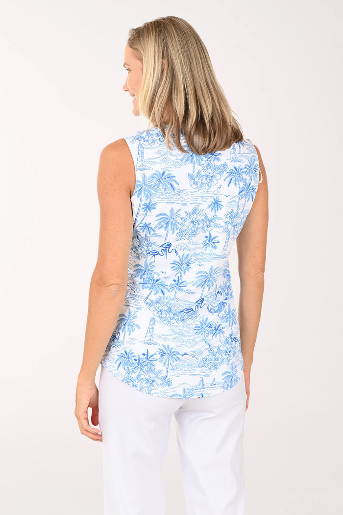 Woman wearing a sleeveless white and blue palm tree top