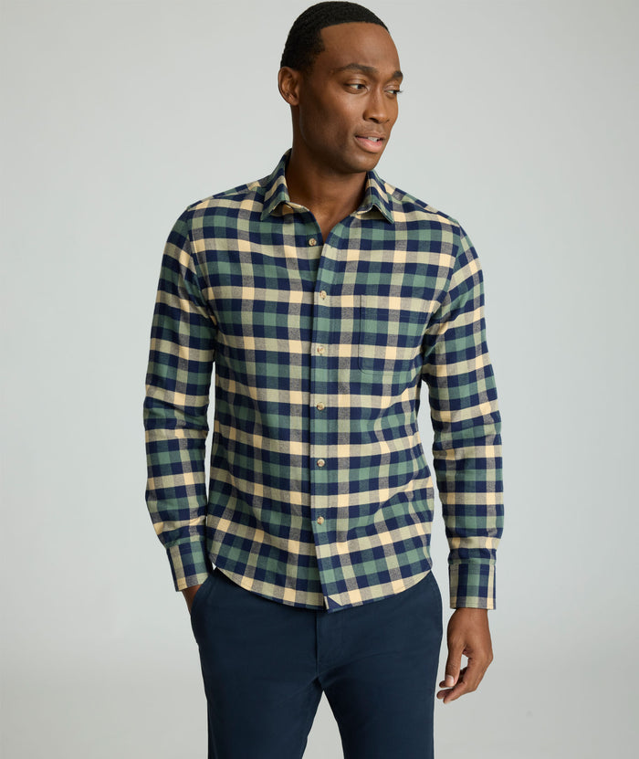 Model is wearing UNTUCKit Flannel Plenville Shirt in green check.