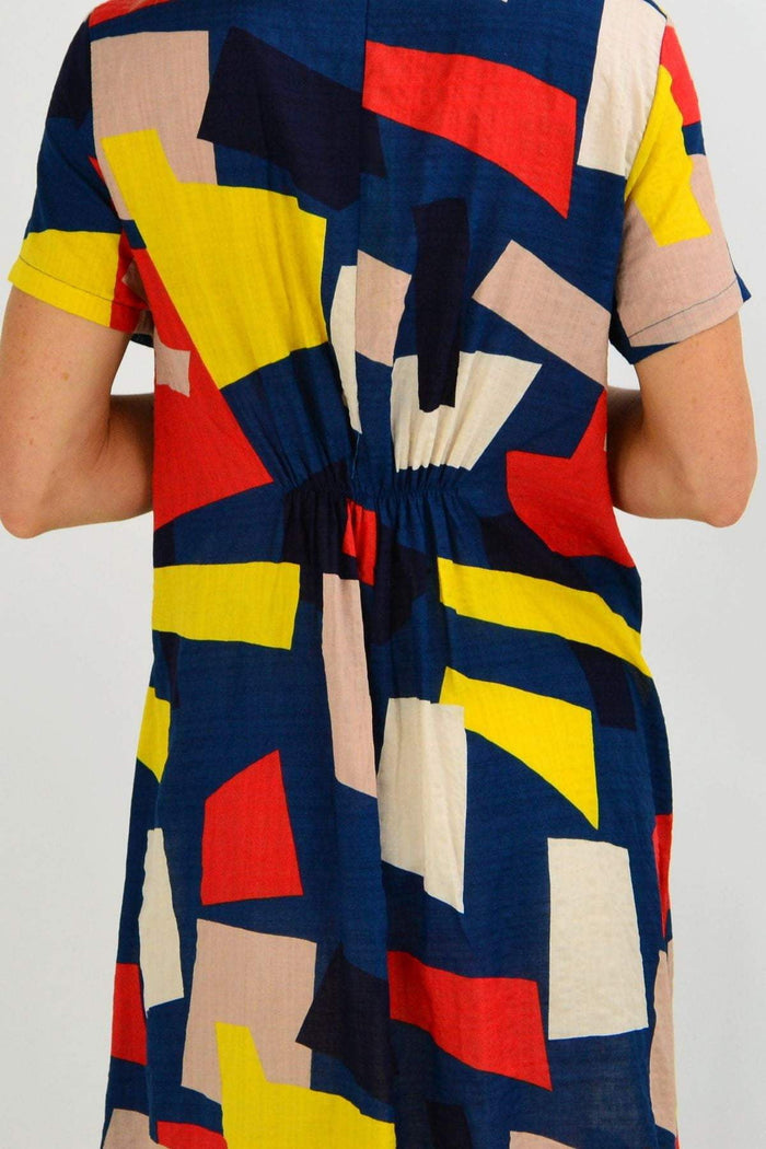 Blue and yellow geometrical shape tunic dress by Wishstone, featuring a long, flowing design with a modern pattern.