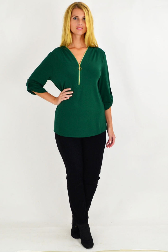 Green Amelia tunic by Envogo, lightweight fabric with a relaxed fit, displayed on a hanger against a neutral background.