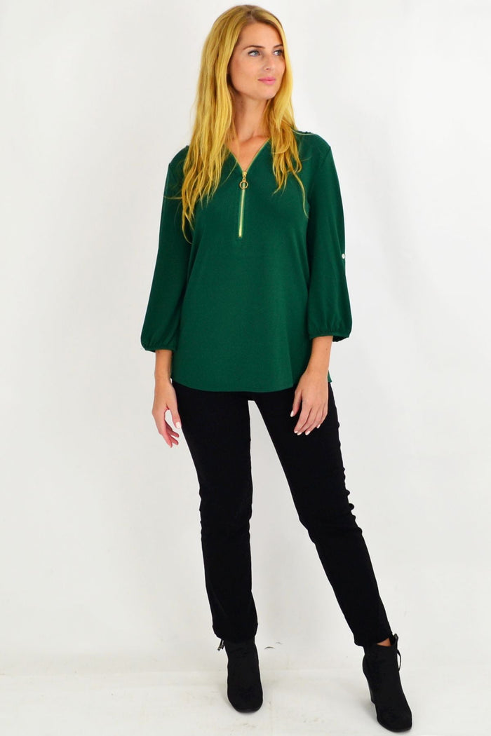 Green Amelia tunic by Envogo, featuring a relaxed fit with long sleeves and a flattering neckline, displayed on a hanger.