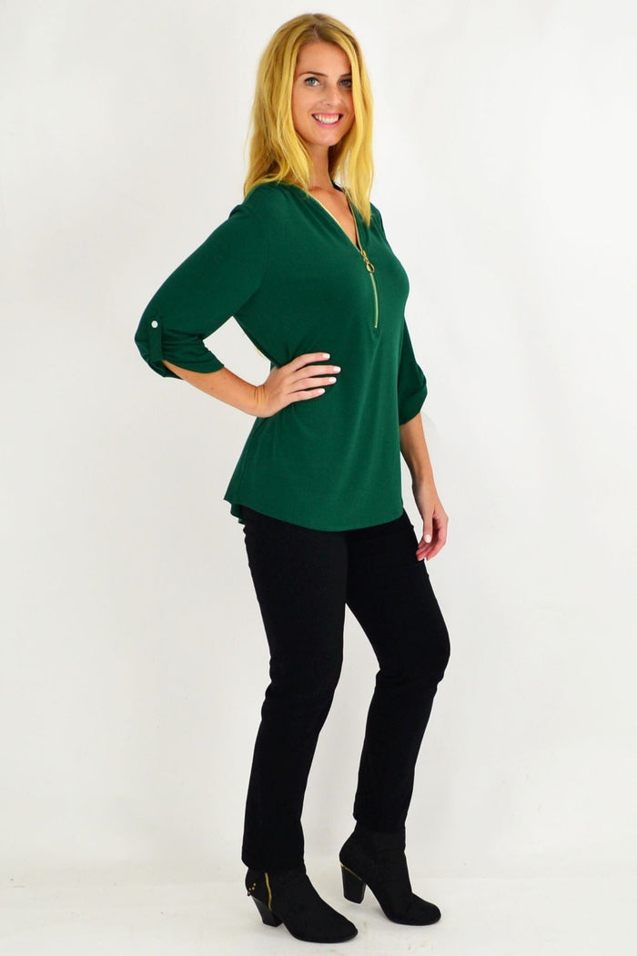 Green Amelia tunic by Envogo displayed on a hanger, showcasing its relaxed fit and vibrant color.