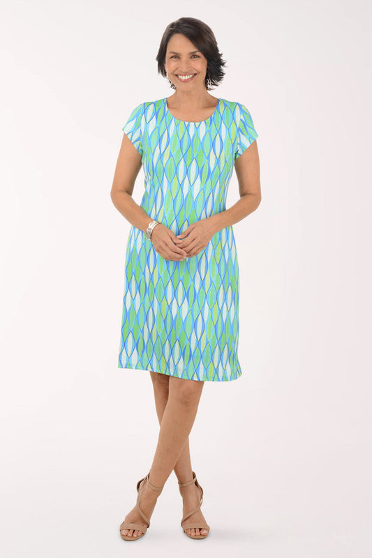 Woman wearing a green and blue patterned dress on a white background