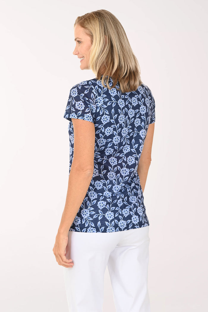 Woman wearing a blue floral short sleeve top