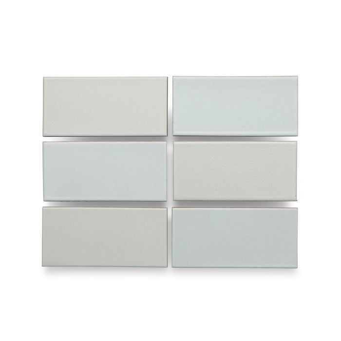 Six Heath Ceramics ceramic tiles glazed in Winter Sky, a matte pale blue/grey glaze