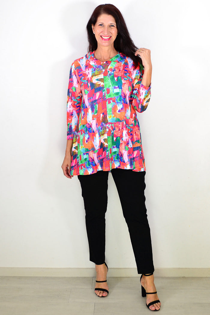Wishstone multicolour abstract print tunic top displayed on a hanger, showcasing vibrant patterns and relaxed fit.