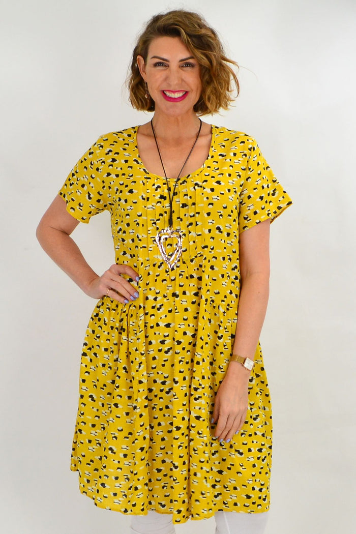 Mustard yellow peasant tunic dress by Hourglass featuring a relaxed fit and bohemian style, shown on a model.