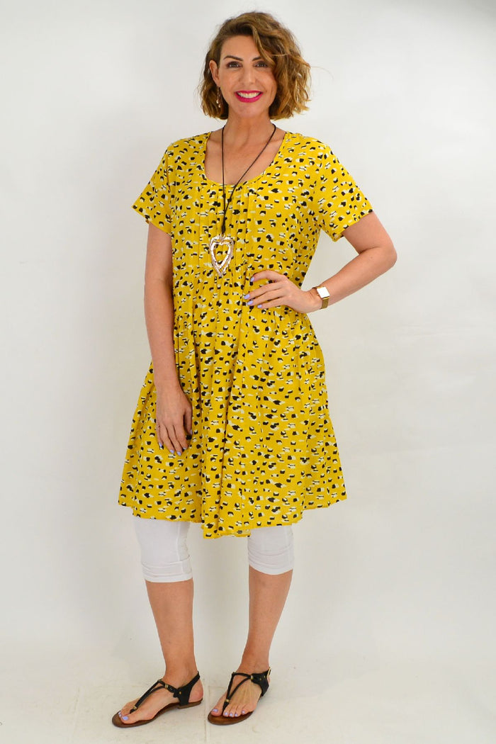 Mustard-yellow Hourglass peasant tunic dress with long sleeves and relaxed fit, displayed on a hanger.