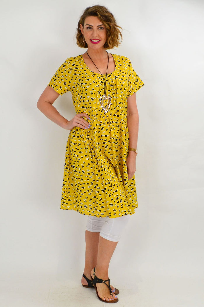 Mustard yellow Hourglass peasant tunic dress with relaxed fit and boho style, featuring long sleeves and neckline detail.