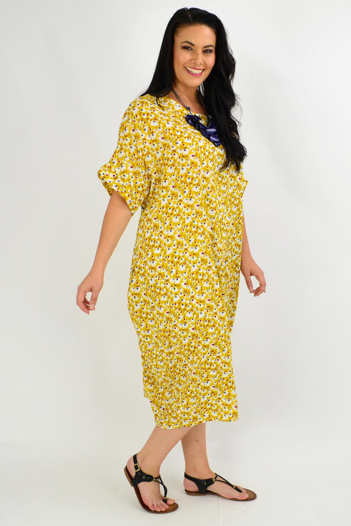Yellow floral tunic dress by La Bay featuring a mustard tiny floral pattern, long sleeves, and a relaxed fit.