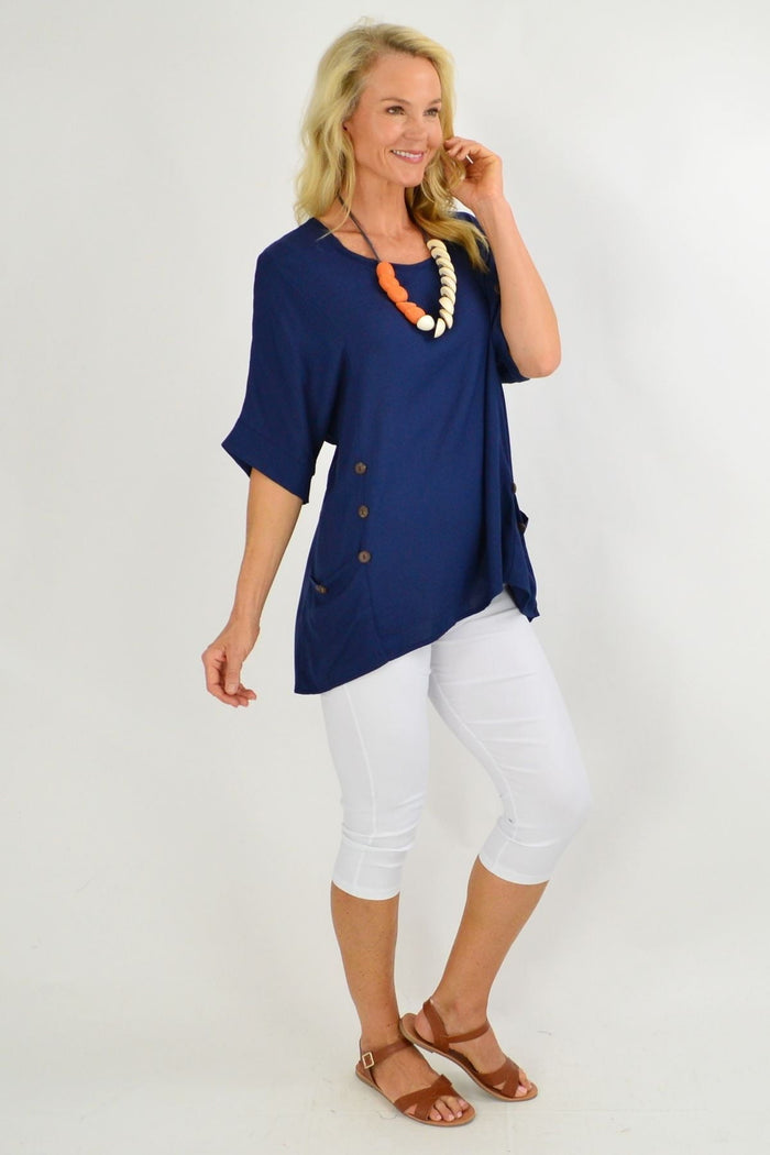 Navy blue Wishstone coconut button sloping sleeve tunic top with relaxed fit and side slits, displayed on a mannequin.