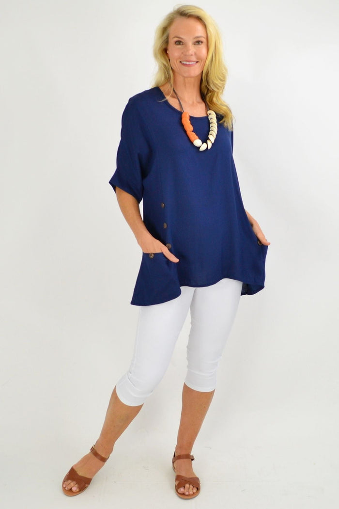Navy blue Wishstone tunic top with coconut buttons and sloping sleeves, styled casually on a model.