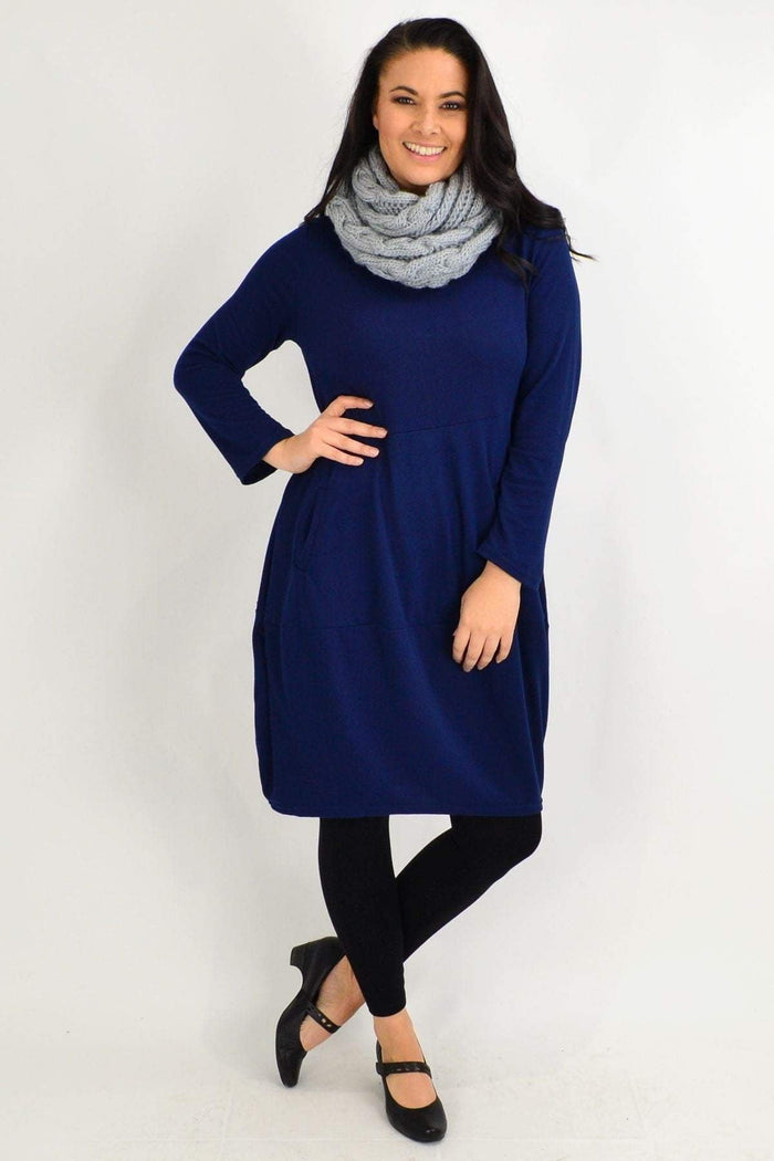Navy blue Peony cocoon winter pocket tunic dress hanging on a mannequin, showing its cozy, oversized fit and side pockets.