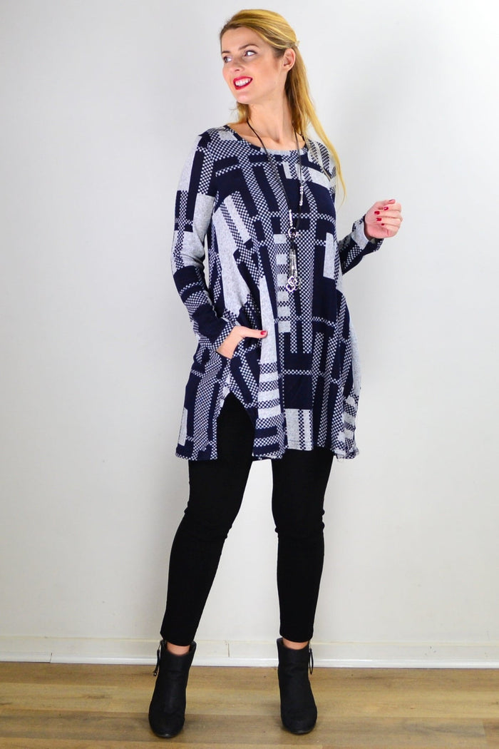 Navy blue and grey knit tunic top by Hourglass, featuring a relaxed fit and soft fabric, displayed on a hanger.
