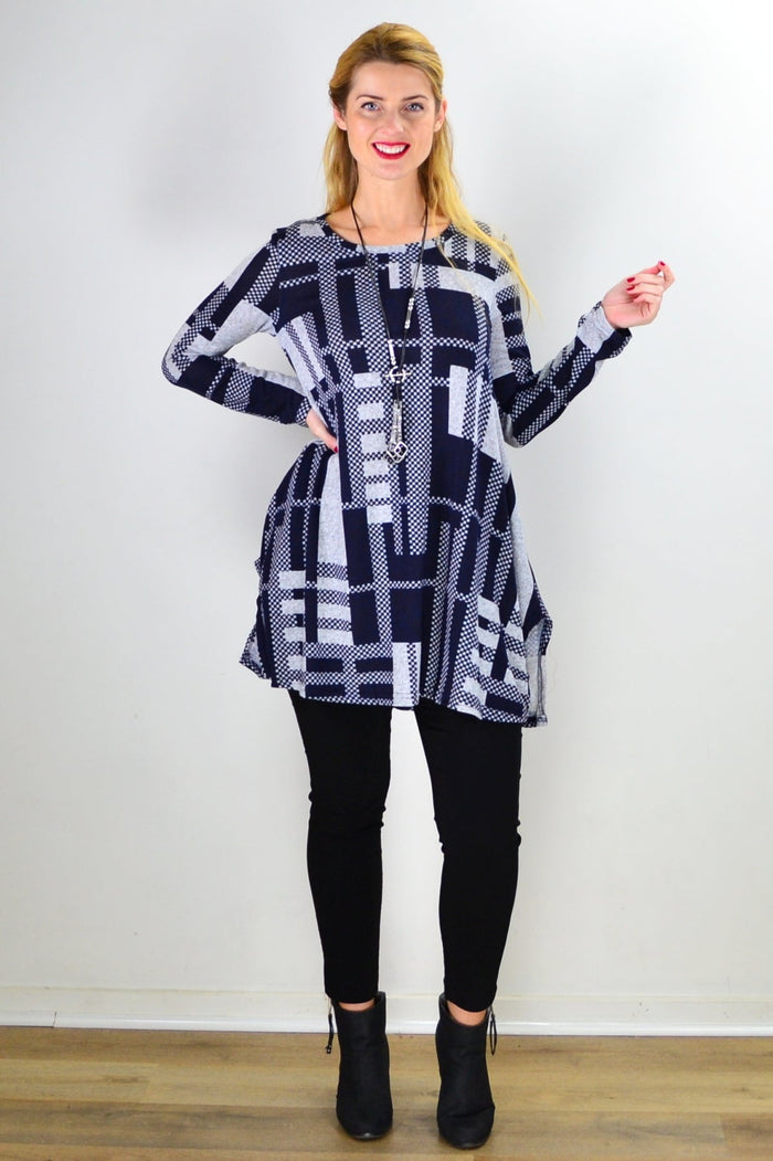 Navy blue and grey knit tunic top by Hourglass, featuring a relaxed fit and cozy textured fabric, displayed on a hanger.