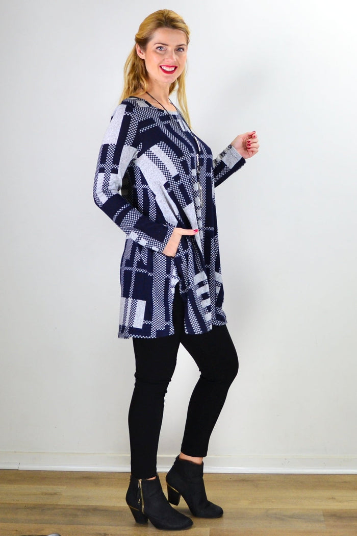Navy blue and grey knit tunic top by Hourglass, featuring long sleeves and a relaxed fit, displayed on a hanger.